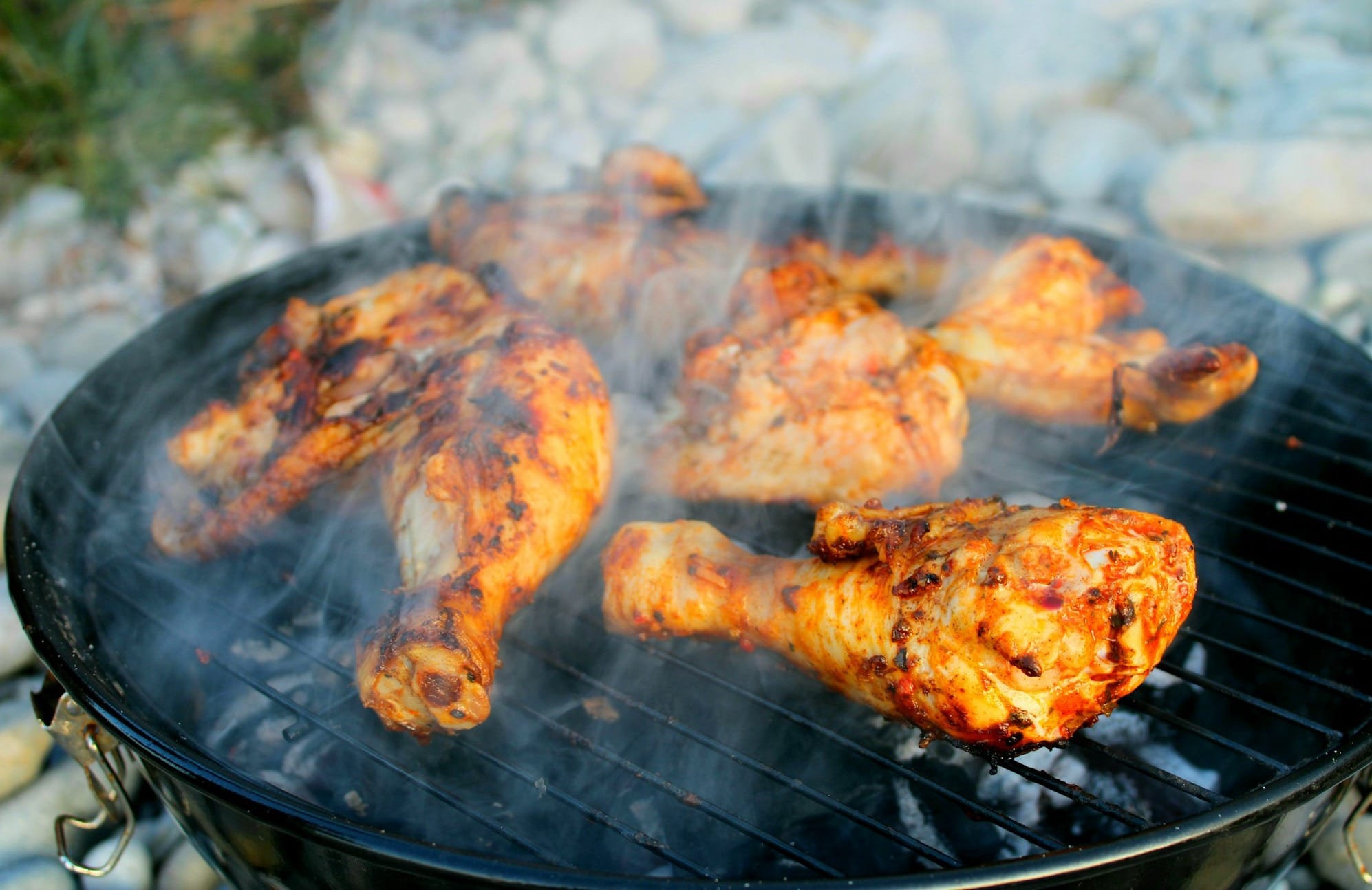 a close up of a grill with chicken on it